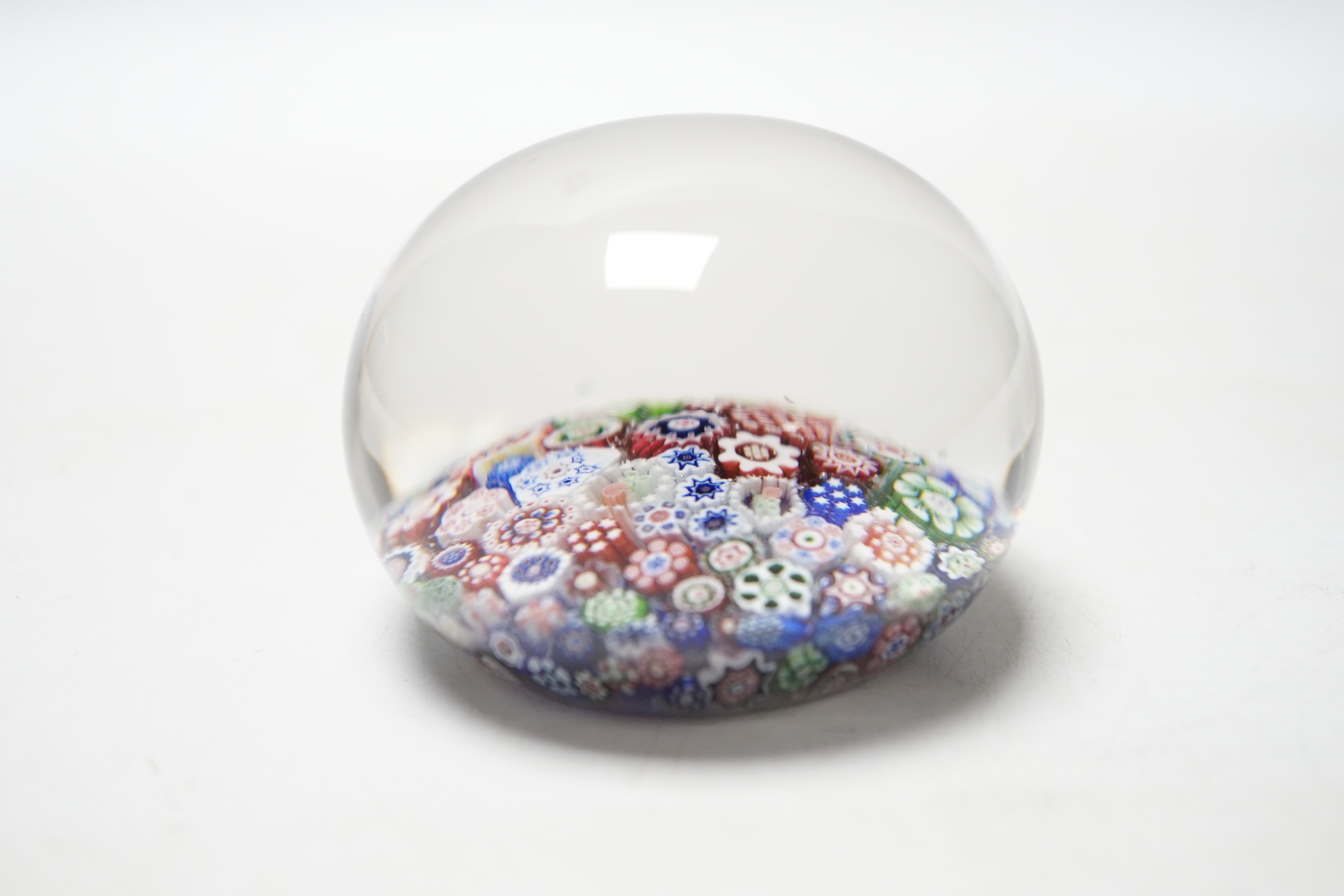 A Baccarat close packed millefiori paperweight with two rose corner, 7cm diameter